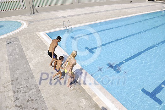 happy young family have fun on swimming pool at summer vacation happy young family have fun on swimming pool at summer vacation