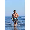 Portrait of a strong young  surf  man at beach on sunset in a contemplative mood with a surfboard