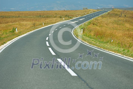 asphalt road through the green field and clouds on blue sky in summer day asphalt road through the green field and clouds on blue sky in summer day