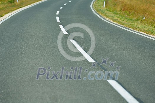 asphalt road through the green field and clouds on blue sky in summer day asphalt road through the green field and clouds on blue sky in summer day