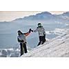 happy couple drivingand relaxing with snowboard and ski at winter seasson on mountain