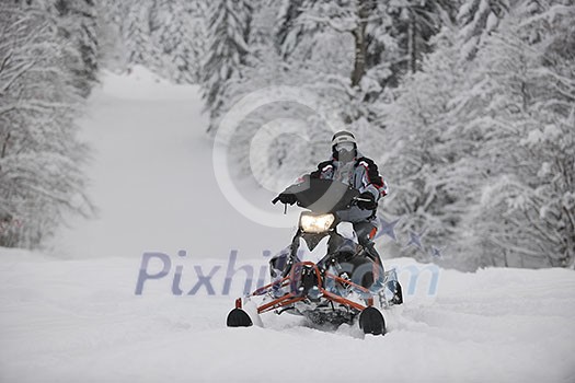 young man posing on snowmobile at beautiful winter day young man posing on snowmobile at beautiful winter day
