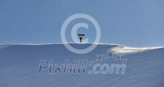 snowboarder relaxing and posing at sunny day on winter season with blue sky in background snowboarder relaxing and posing at sunny day on winter season with blue sky in background