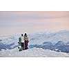 happy young snowboarder couple relax at top of mountain at beautiful sunny winter day