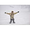 snowboarder relaxing and posing at sunny day on winter season with blue sky in background