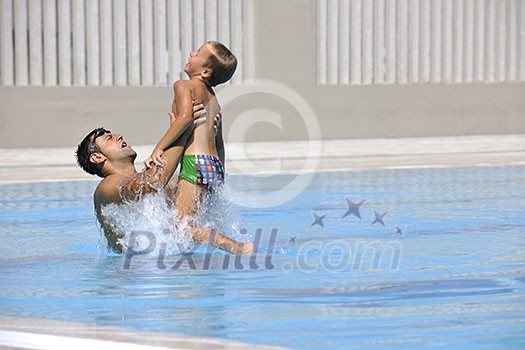 happy father and son have fun at swimming pool happy father and son have fun at swimming pool