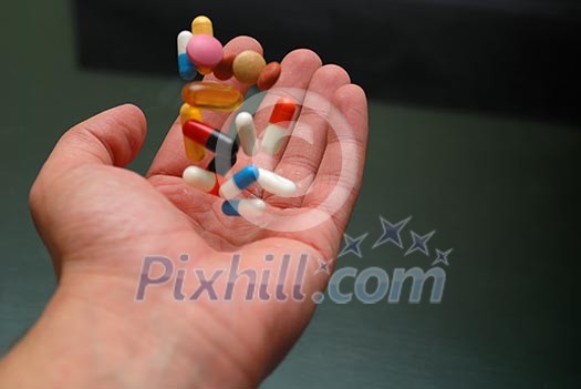 pills in human hand pills in human hand