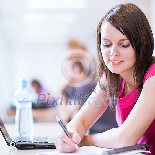 in the library - pretty female student with laptop and books working in a high school library (color toned image) in the library - pretty female student with laptop and books working in a high school library (color toned image)