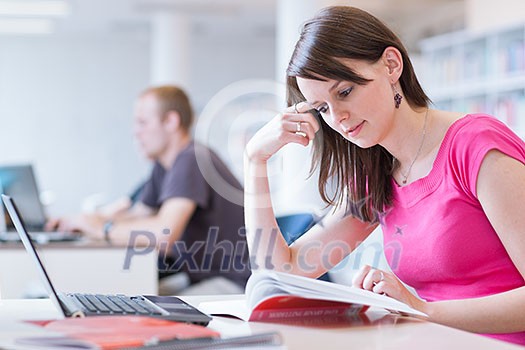 in the library - pretty female student with laptop and books working in a high school library (color toned image) in the library - pretty female student with laptop and books working in a high school library (color toned image)