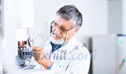 senior male researcher carrying out scientific research in a lab using a gas chromatograph (shallow DOF; color toned image) senior male researcher carrying out scientific research in a lab using a gas chromatograph (shallow DOF; color toned image)