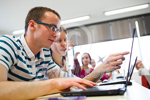 College students sitting in a classroom, using laptop computers during class (shallow DOF) College students sitting in a classroom, using laptop computers during class (shallow DOF)