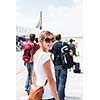 Departure - young woman at an airport about to board an aircraft on a sunny summer day