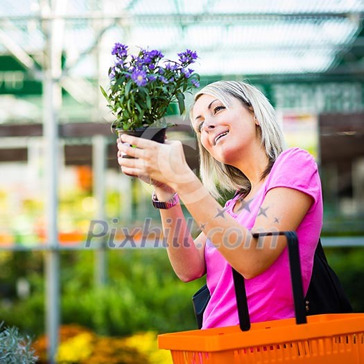 Young woman buying flowers at a garden center