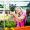 Young woman buying flowers at a garden center