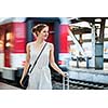 Pretty young woman at a train station