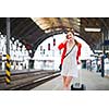 Pretty young woman at a train station