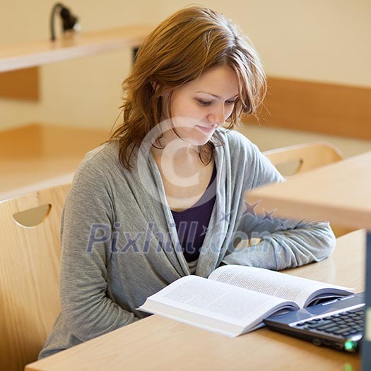 pretty female college student in a llibrary (color toned image) pretty female college student in a llibrary (color toned image)