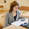 pretty female college student in a llibrary (color toned image)