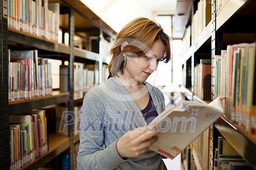 pretty female college student in a llibrary (color toned image) pretty female college student in a llibrary (color toned image)