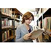 pretty female college student in a llibrary (color toned image)