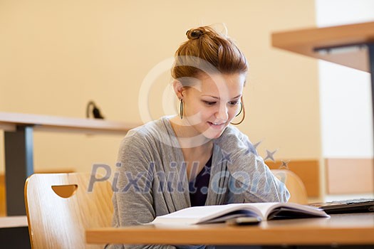 pretty female college student in a llibrary (color toned image) pretty female college student in a llibrary (color toned image)