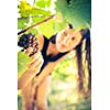 Grapes in a vineyard being checked by a female vintner (color toned image)