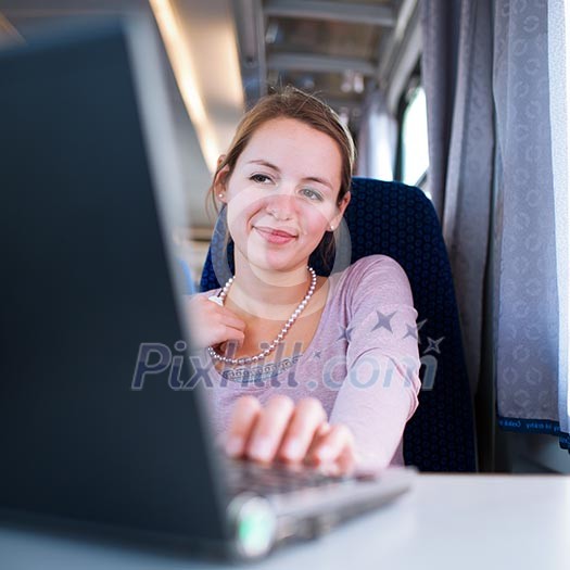 Young woman using her laptop computer while on the train (shallow DOF; color toned image) Young woman using her laptop computer while on the train (shallow DOF; color toned image)