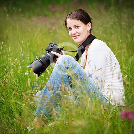 pretty young woman with a DSLR camera outdoors, taking pictures pretty young woman with a DSLR camera outdoors, taking pictures