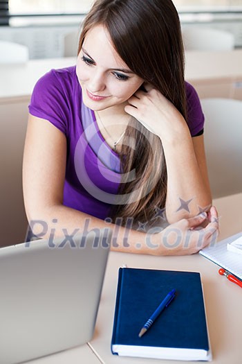 Pretty female college student in classroom (color toned image) Pretty female college student in classroom (color toned image)