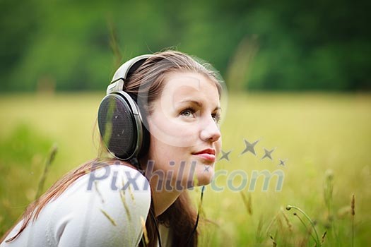 portrait of a pretty young woman listening to music on her mp3 player outdoors (daydreaming) portrait of a pretty young woman listening to music on her mp3 player outdoors (daydreaming)