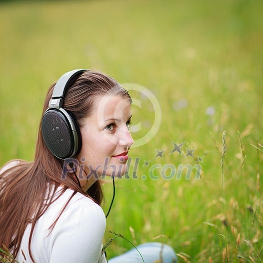 portrait of a pretty young woman listening to music on her mp3 player outdoors (daydreaming) portrait of a pretty young woman listening to music on her mp3 player outdoors (daydreaming)