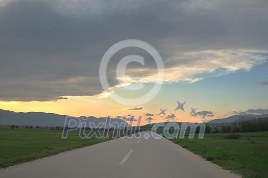 landscape in nature and countryroad adventure with beautiful sunset and dramatic clouds and sky landscape in nature and countryroad adventure with beautiful sunset and dramatic clouds and sky