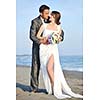 happy just married young couple celebrating and have fun at beautiful beach sunset
