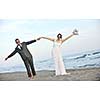 happy just married young couple celebrating and have fun at beautiful beach sunset