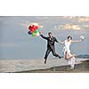 happy just married young couple celebrating and have fun at beautiful beach sunset
