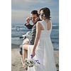 wedding sce of bride and groom just married couple on the beach ride white scooter and have fun