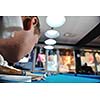 young pro billiard player finding best solution and right angle at billard or snooker pool sport  game 