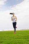 Running in city park. Woman runner outside jogging at morning with Dubai urban scene in background