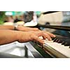 Man playing melody on piano