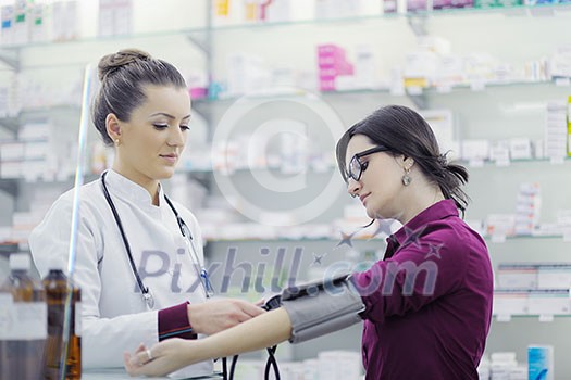 doctor checking blood pressure and heart rate in a hospital or in pharmacy with young female patient doctor checking blood pressure and heart rate in a hospital or in pharmacy with young female patient