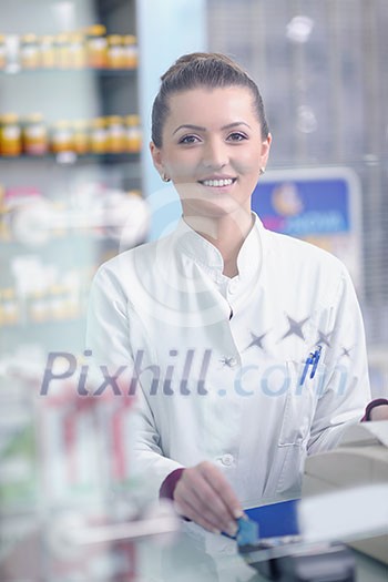 Happy cheerful pharmacist chemist woman standing in pharmacy drugstore Happy cheerful pharmacist chemist woman standing in pharmacy drugstore