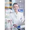 Happy cheerful pharmacist chemist woman standing in pharmacy drugstore