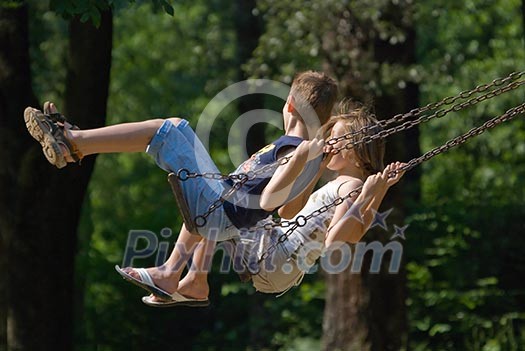 girl and boy challenge on swing in park (NIKON D80; 10.6.2007; 1/1000 at f/6.3; ISO 400; white balance: Auto; focal length: 270 mm) girl and boy challenge on swing in park (NIKON D80; 10.6.2007; 1/1000 at f/6.3; ISO 400; white balance: Auto; focal length: 270 mm)
