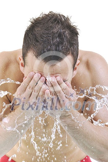 young man washing face with clean water and representing hygiene and mans beauty concept young man washing face with clean water and representing hygiene and mans beauty concept