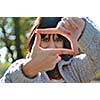 Cute young woman pretending to see the world through a lens