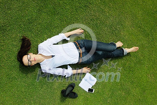 Young student woman reading a book and study in the park