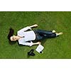 Young student woman reading a book and study in the park