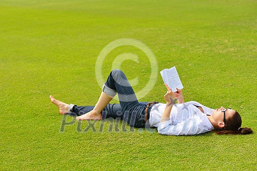 Young student woman reading a book and study in the park Young student woman reading a book and study in the park