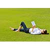 Young student woman reading a book and study in the park