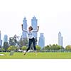happy young student woman with laptop in city park study